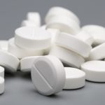 Heap of white round pills medical